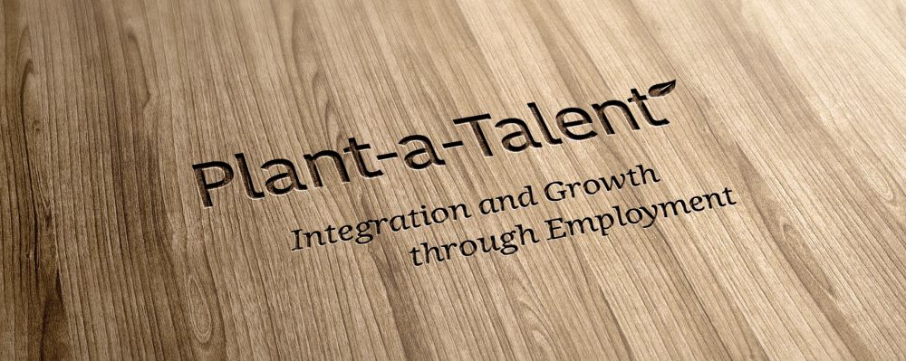 Plant a Talent – Integration and Growth through Employment, in Holz graviert